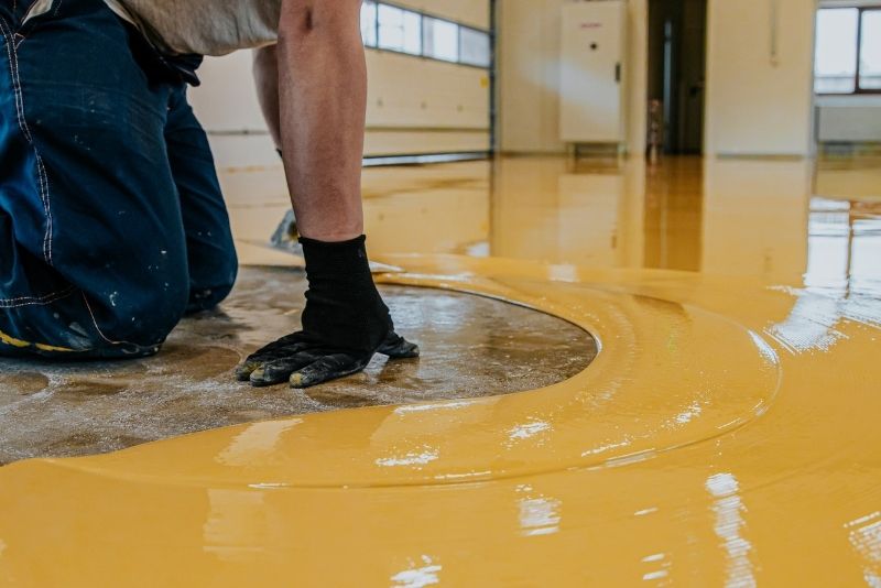 spreading epoxy mixture on the floor