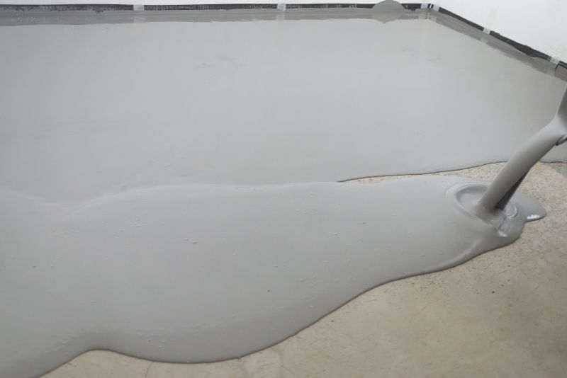 Non-slip epoxy floor coating mixture being poured in a Hobart property