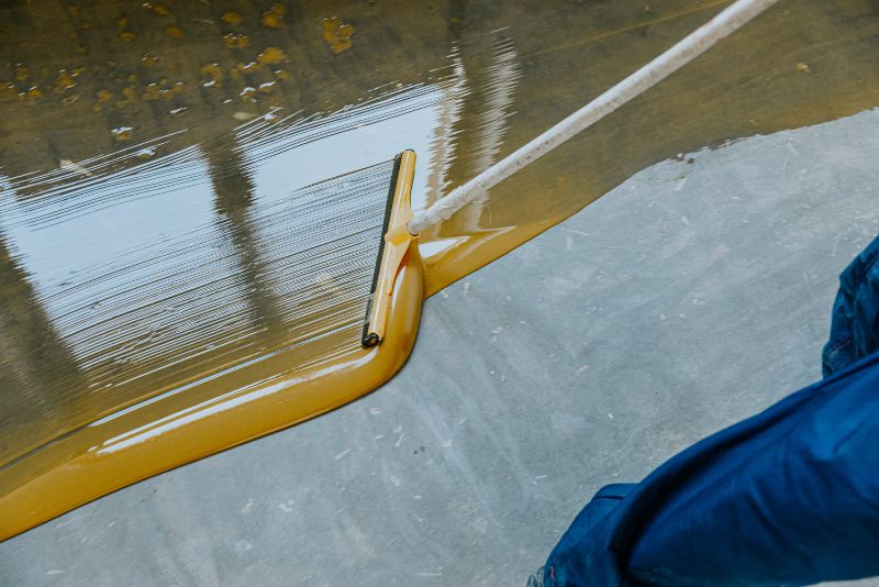 applying epoxy coating on concrete floor