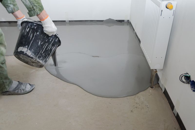 Epoxy mixture being poured onto a concrete floor overlay in Brighton